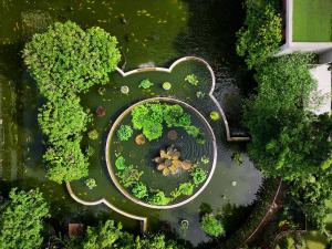 an overhead view of a park with trees and a river at Hilton Colombo Hotel in Colombo