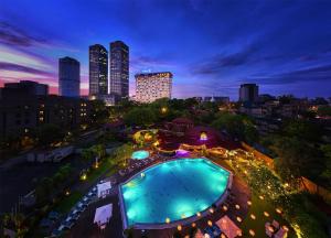 a pool with a view of the city at night at Hilton Colombo Hotel in Colombo