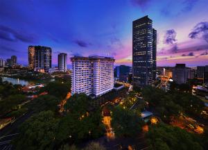 a city skyline at night with tall buildings at Hilton Colombo Hotel in Colombo