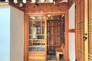 a wooden door in a room with a staircase at Moonjarak Dalbit Hanok in Seoul