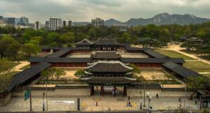 an asian building with a city in the background at Moonjarak Dalbit Hanok in Seoul