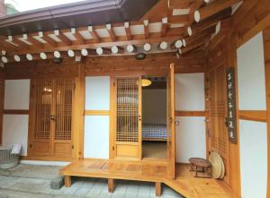 a wooden house with a bed inside of it at Moonjarak Dalbit Hanok in Seoul