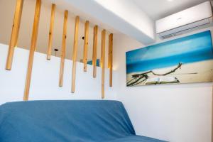 a room with skis on the wall and a blue couch at MNS Accommodations in Salamina +47 photos