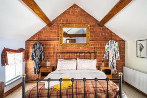 a bedroom with a bed and a brick wall at Sorley Boys Snug in Derry Londonderry +12 photos