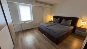 a small bedroom with a bed and a window at Am Gebirgsbad in Kurort Jonsdorf +6 photos
