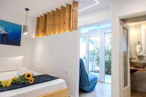 a bedroom with a bed with flowers on it at MNS Accommodations in Salamina