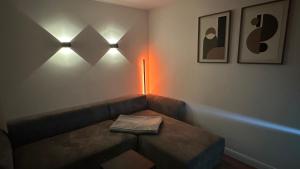 a room with a couch with a table and lights at Am Gebirgsbad in Kurort Jonsdorf