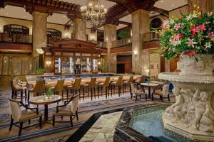 a restaurant with tables and chairs and a bar at Peabody Memphis in Memphis