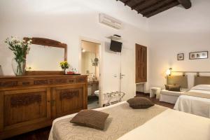 a hotel room with two beds and a mirror at B&B Arco Del Lauro in Rome