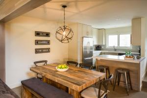 a kitchen with a wooden table with chairs and a dining room at Ridge 91 at Elkhorn in Elkhorn Village