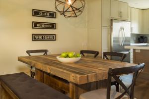 a kitchen with a wooden table with a bowl of fruit on it at Ridge 91 at Elkhorn in Elkhorn Village