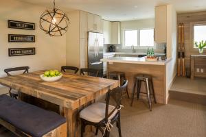 a kitchen with a wooden table with a bowl of fruit on it at Ridge 91 at Elkhorn in Elkhorn Village