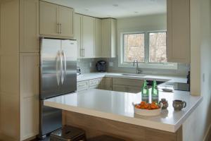 a kitchen with a refrigerator and a counter with a bowl of oranges at Ridge 91 at Elkhorn in Elkhorn Village +16 photos
