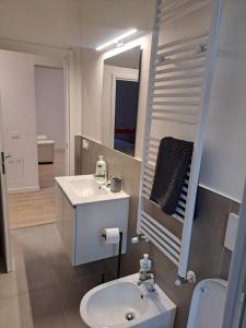 a white bathroom with a sink and a mirror at San Francesco Home in Terni +114 photos