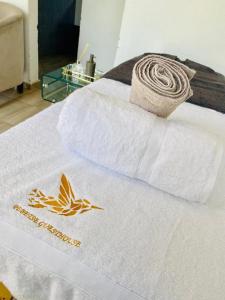 a bed with a white towel with a sign on it at Pebetse Guesthouse in Acornhoek