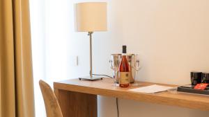 a table with a bottle of wine and a blender at Hotel Diana in Pompei