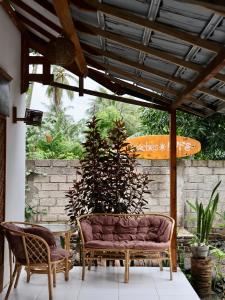 a patio with two chairs and a table at beaches Lyfe Rooms in Kuta Lombok