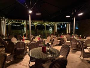 an outdoor restaurant with tables and chairs and lights at Guy Fawkes Inn in York