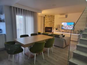 a living room with a table and chairs and a couch at Casa do Azeite in Torre de Moncorvo