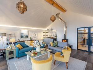a living room with blue couches and a table at 5 Bed in Fowey oc-93849 in Polruan