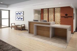 an office lobby with a reception desk and chairs at Candlewood Suites Beachwood Cleveland by IHG in Beachwood