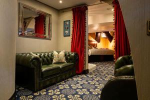 a living room with a couch and a bedroom at Ocean Mist Leith in Edinburgh