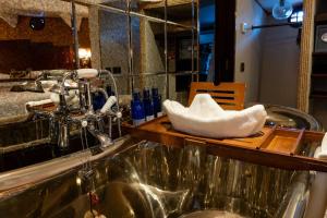 a bathroom with a sink with a bowl of towels at Ocean Mist Leith in Edinburgh +99 photos