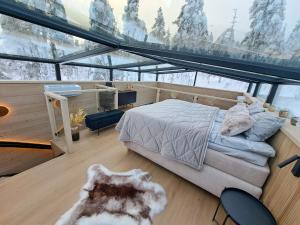 a bedroom with a bed in a room with windows at Levi Lapland Luxury Igloos C in Levi +29 photos