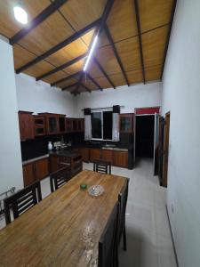a large kitchen with a wooden table and chairs at X38 Venture in Kitulgala