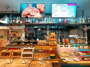 a bakery with a counter with different types of food at Ostello Bello Milano Duomo in Milan