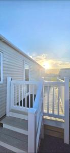 a porch with a white railing on a house at Shellie's Summer Breeze Retreat in Heysham