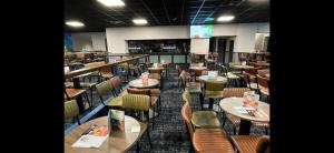 a restaurant with tables and chairs in a room at Shellie's Summer Breeze Retreat in Heysham