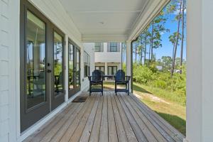 two chairs sitting on the porch of a house at Famiy and Pet friendly, close to Wharf, pool in Orange Beach
