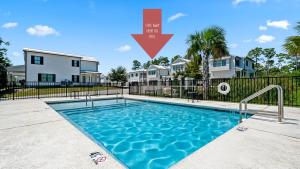 a swimming pool in front of a house at Famiy and Pet friendly, close to Wharf, pool in Orange Beach
