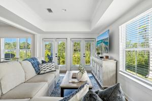 a living room with a couch and some windows at Famiy and Pet friendly, close to Wharf, pool in Orange Beach