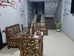 a row of chairs in a room with stairs at Abi Hotel & Rastaurant in Jaffna