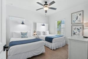 a bedroom with two beds and a ceiling fan at Famiy and Pet friendly, close to Wharf, pool in Orange Beach +46 photos