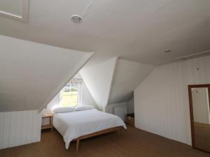 a bedroom with a white bed and a window at 36 Crowthers Hill in Dartmouth