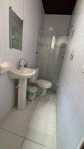 a white bathroom with a sink and a toilet at Pousada Lua Nova in Paraty +50 photos