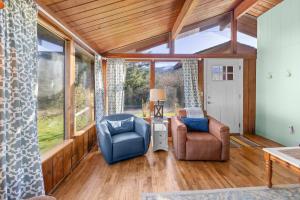 a living room with a couch and a chair at The Lily Pad in Rockaway Beach +33 photos