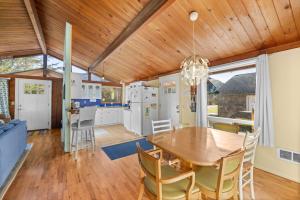 a kitchen and dining room with a wooden ceiling at The Lily Pad in Rockaway Beach