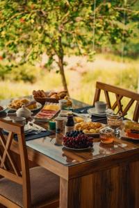 a table full of food on a table with chairs at Vinícola & Pousada Terragnolo in Bento Gonçalves +50 photos