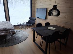 a room with a table and chairs and a room with a window at Levi Lapland Luxury Igloos C in Levi