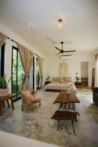a living room with a bed and a couch at El Valle Villas in Santa Bárbara de Samaná