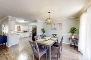 a dining room and kitchen with a table and chairs at 6 Mi to Dtwn: 'Macon Memories' Dog-Friendly Haven in Riverside Park