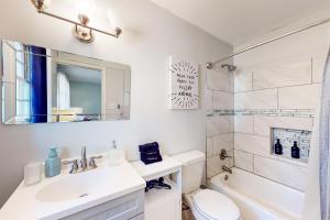 a bathroom with a sink and a toilet and a shower at 6 Mi to Dtwn: 'Macon Memories' Dog-Friendly Haven in Riverside Park +24 photos