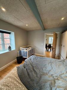a bedroom with a bed and a crib in it at AE323-Soby-Aero-Sondervejen-5 in Søby