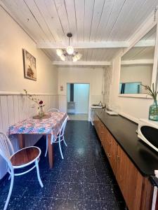 a kitchen with a table and chairs in a room at Departamento Céntrico 3 in El Bolsón +5 photos