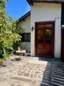 a patio with a table and a wooden door at Departamento Céntrico 3 in El Bolsón
