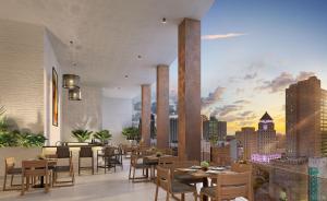 a restaurant with tables and chairs and a view of a city at Upscale Downtown Condo Pool Gym & Skyline Views in Miami